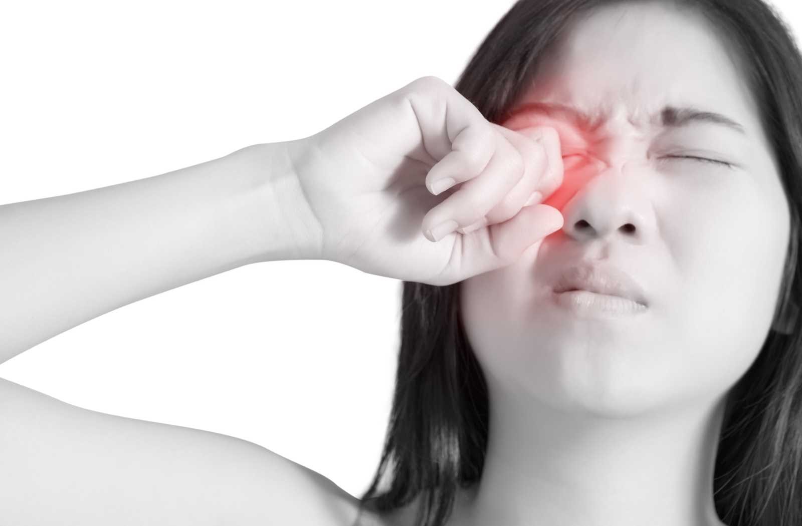 black and white photo of woman experiencing painful eye disease symptoms glowing red