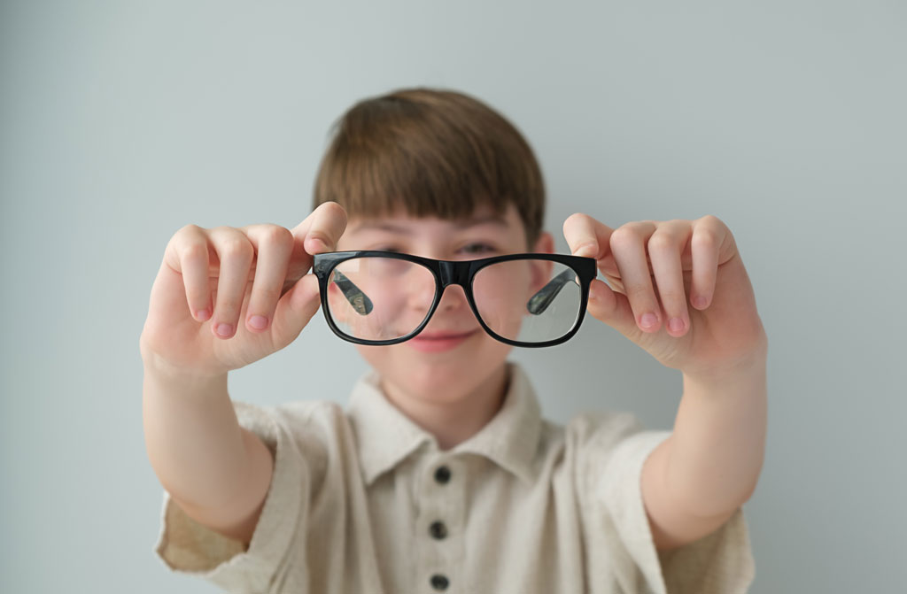 Boy showing glasses